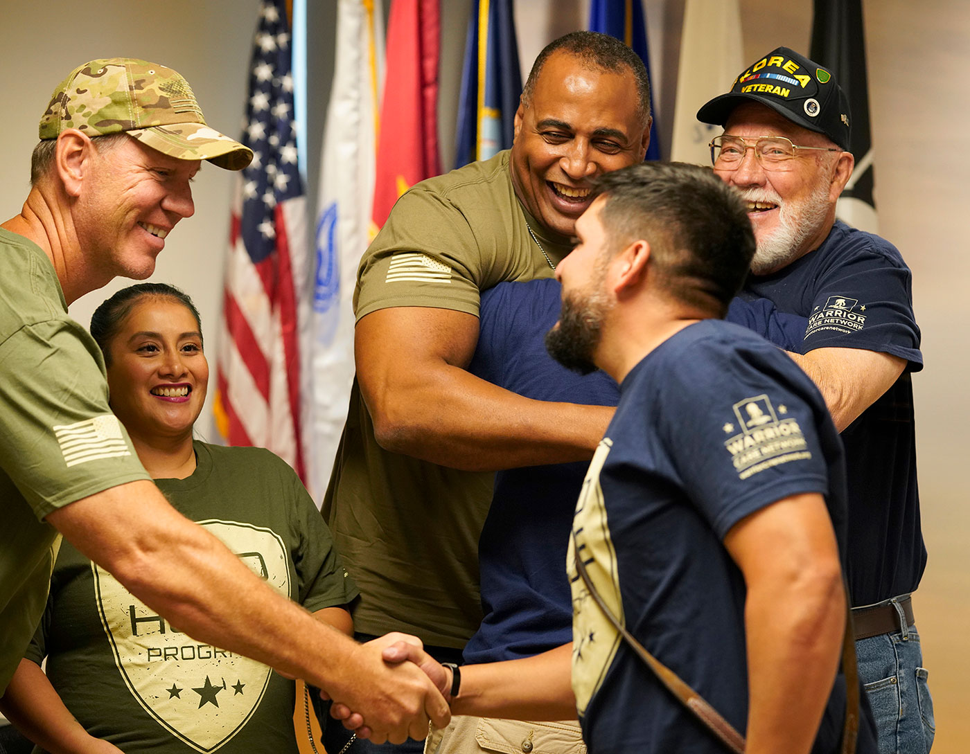 military uniformed men and women shaking hands with one another