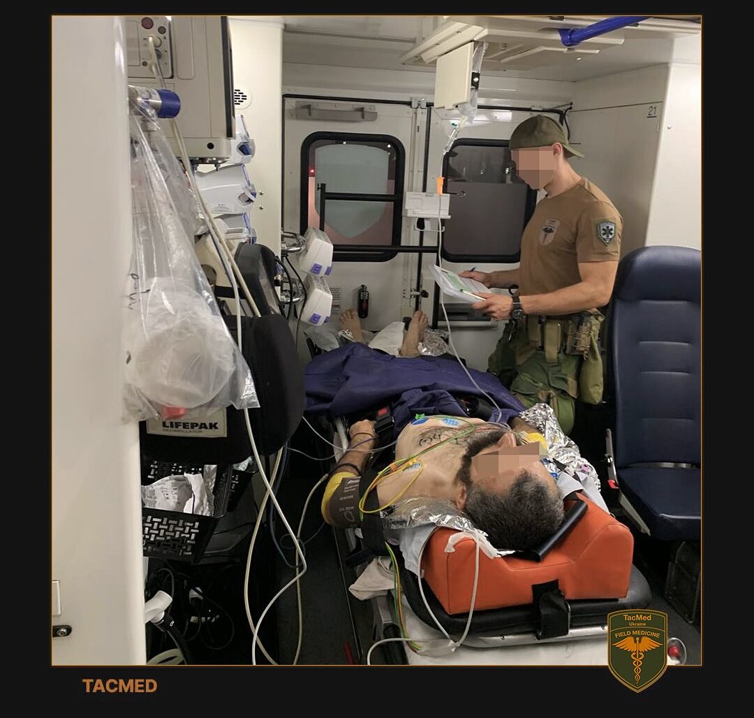 volunteer tending to a wounded soldier in an ambulance