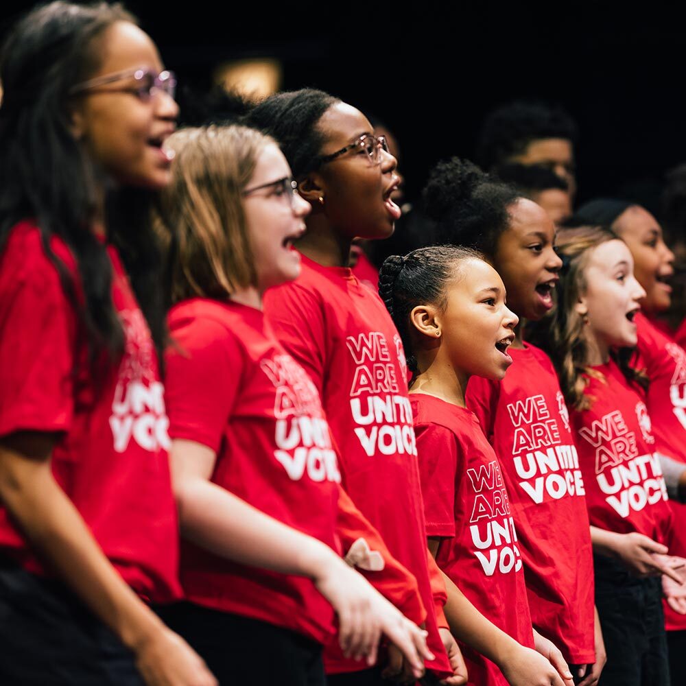 children's choir singing in matching red t-shirts